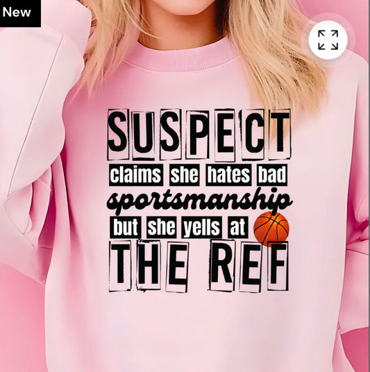 T-SHIRT Suspect claims she hates bad sportsmanship, but yells at the ref
